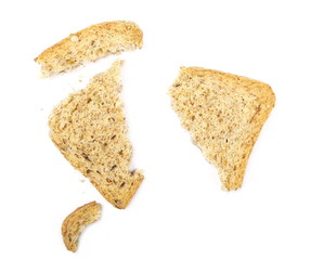 Broken rye toast slices with seeds isolated on white background, top view