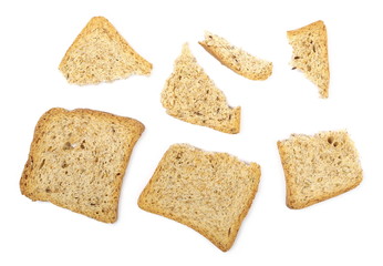 Broken rye toast slices with seeds isolated on white background, top view