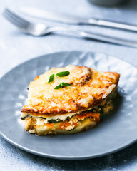 Traditional greek Мoussaka on a grey plate