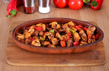 Chicken pepper tomato and vegetable turkey feed in clay pot