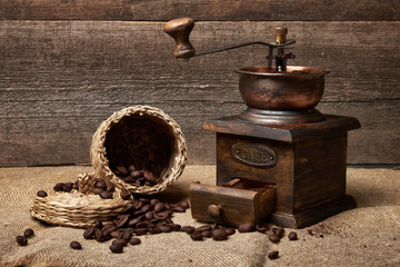 still life of coffee beans in jute bags with coffee grinder