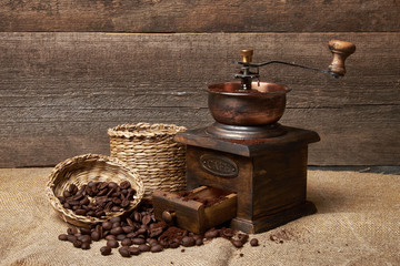still life of coffee beans in jute bags with coffee grinder - obrazy, fototapety, plakaty