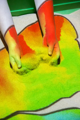 Interactive sandbox with a projector that color sand colored lights