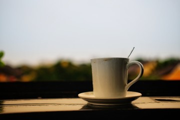 cup of coffee on wooden table