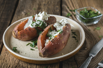 Baked sweet potato with cream cheese, yogurt and fresh herbs