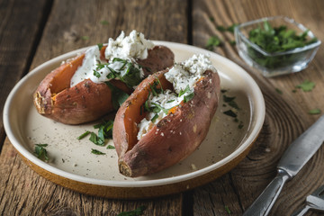 Baked sweet potato with cream cheese, yogurt and fresh herbs