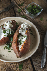 Baked sweet potato with cream cheese, yogurt and fresh herbs