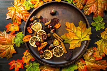 Autumn composition with dried leaves, spices decorations and wooden plate , top view