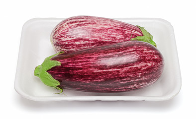 Two eggplant graffiti in a white plastic packaging. Isolation on a white background. Saturated bright colors. Top side view.