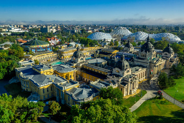 Fototapeta na wymiar Aerial view of Szechenyi thermal spa with azure pool and the futuristic domes of the zooin the middle of Varosliget the green soul of Budapest Hungary