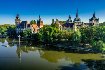 Fototapeta na wymiar Vajdahunyad castle in Varosliget Budapest Hungary with reflection in the water