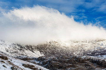 Fototapeta na wymiar Snow covered mountain range in snowdonia, wales, United Kingdom.