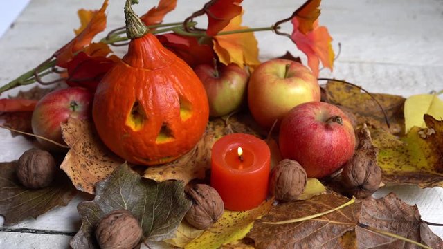 candle, apples, pumpkin, Autumn leaves on wooden table. halloween