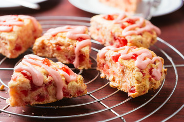 Homemade cherry almond scones on a cooling rack.