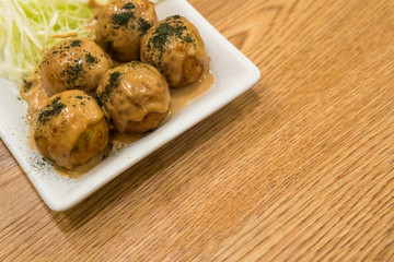 TAKOYAKI Octopus Dumplings on wooden table
