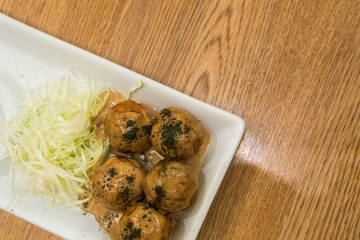 TAKOYAKI Octopus Dumplings on wooden table