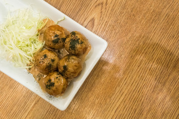 TAKOYAKI Octopus Dumplings on wooden table