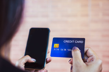 woman hand holding using credit card and smart phone for payment,shopping online 