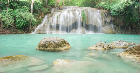 Naklejka premium Waterfall in rain forest at Erawan National Park at Kanchanaburi in Thailand