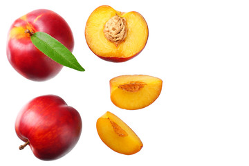 Nectarine with green leaf and slices isolated on white background. top view