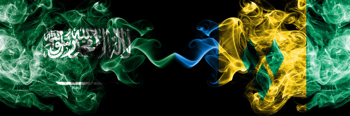 Saudi Arabia Kingdom vs Saint Vincent and the Grenadines smoky mystic flags placed side by side....