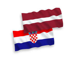Naklejka premium National vector fabric wave flags of Latvia and Croatia isolated on white background. 1 to 2 proportion.