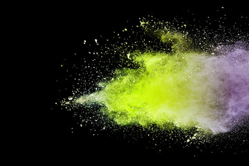 Explosion of green powder isolated on black background. Abstract colored background. holi festival.