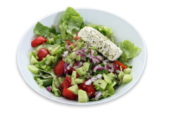 Greek salad with lettuce, tomatoes, cucumbers, peppers, red onion, oregano and feta