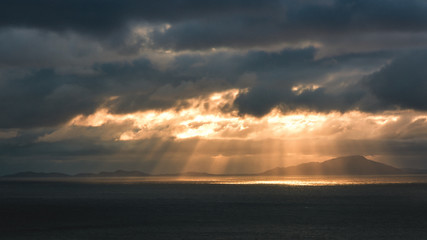 Beautiful seascape splitting rays cloudy clouds sun light sunset Scotland Neist Point