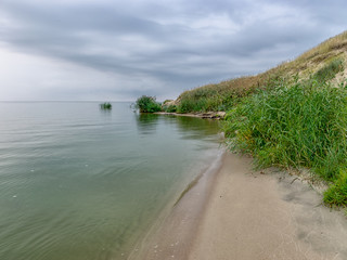landscape with sea and sand dune shore, shore slip, calm water, Curonian Spit, Nida,, Lithuania. Baltic dunes, UNESCO heritage