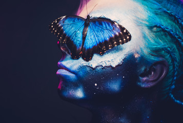 Beautiful woman with blue hair and butterfly