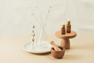Glass flask and test tubes with flowers for medical health or cosmetic science research laboratory