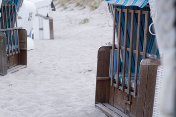 Abandoned and locked beach chairs on the beach - end of summer concept