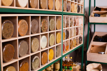 Food and spices in glass jars and wooden boxes