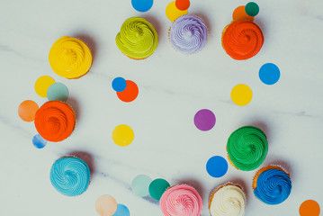 Colourfull cupcakes flat lay with vivid circles