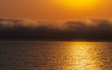 Heavy dramatic clouds and bright sky over the Atlantic Ocean. Beautiful african sunset