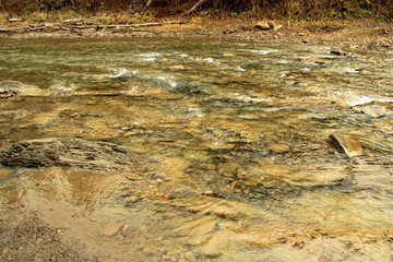Mountain river with rapid current. Water flow