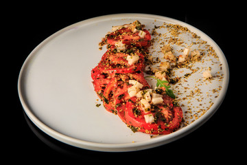 delicious sliced tomato exquisite decorated with assorted herbs