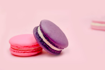 French macarons (macaroons) cake,  delicious sweet dessert on a pink background with copyspace, food background concept, selective focus.