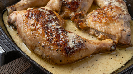 Fried legs in a pan in a sauce with spices