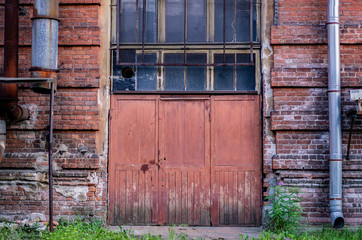 Wooden door in an old brick manufacturing building