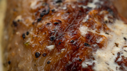 Juicy fried skin on a chicken leg. Macro photo