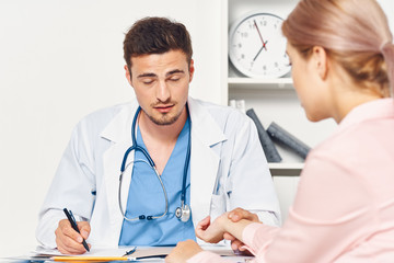 portrait of doctor with patient in office