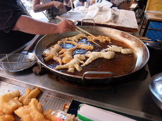 cooking in a panFlour molded in various forms of animals, called "Pa Tong Ko" with coffee, tea and soy milk in Chiang Mai, Thailand.