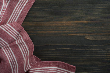 Dark wooden background with red napkin