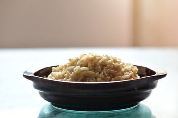 Cooked brown rice in the bowl on the dining table