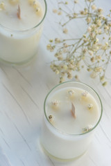 Сandle making - Handmade soy wax candle in glass on white background. Front view. Healthy lifestyle concept