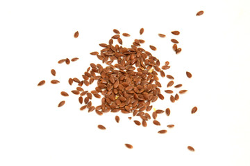 Some linseeds spread out on white background seen from above