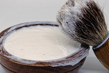 razor brush and razor cream in wooden bowl