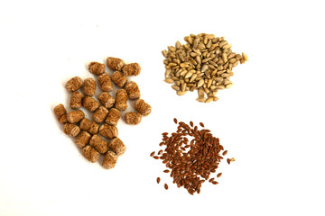 Cereals and seeds: sunflower, flax and bran closeup on a white background